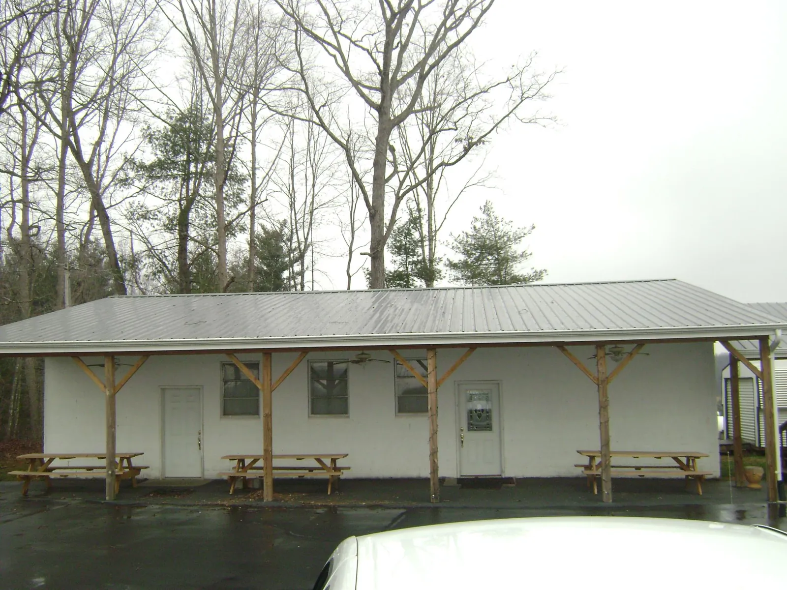 Gray metal roof over a block building with a timber post porch in Wise River